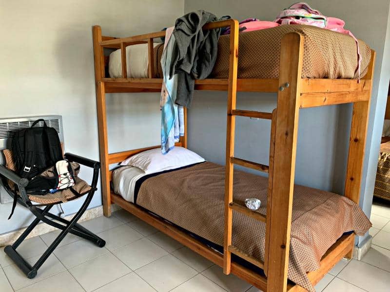 wooden bunk beds in family room at El Pueblo Tamlelt hotel