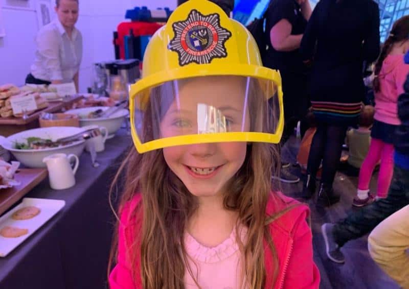 child wearing fire officers helmet dress up