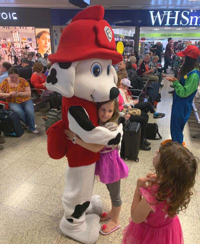 child with marshall from paw patrol at malta airport