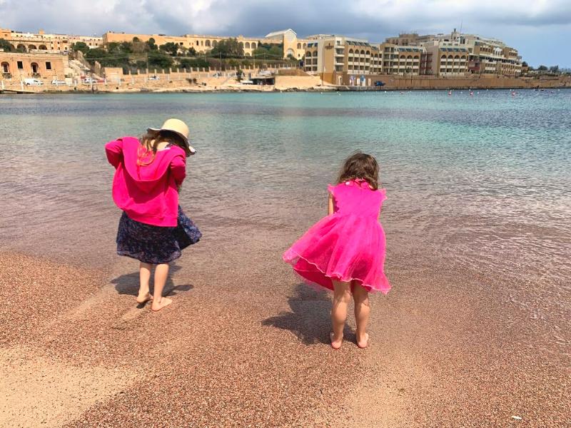 children playing on beach at st george's bay malta