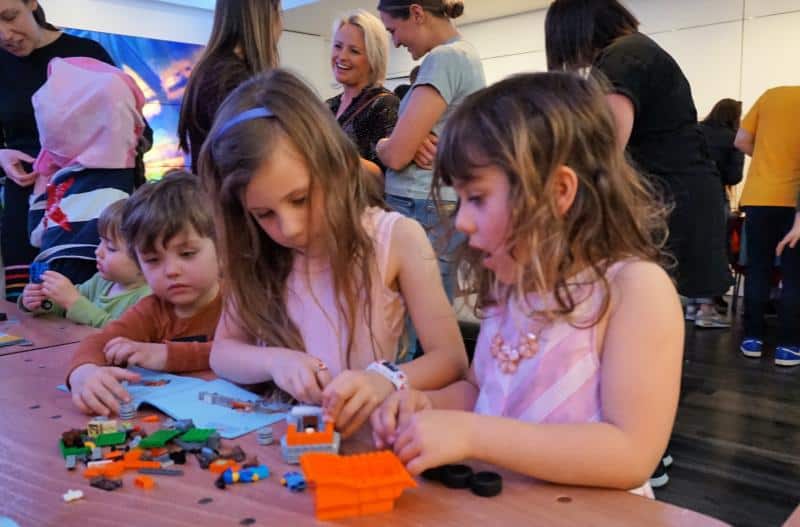 girls building LEGO City toys