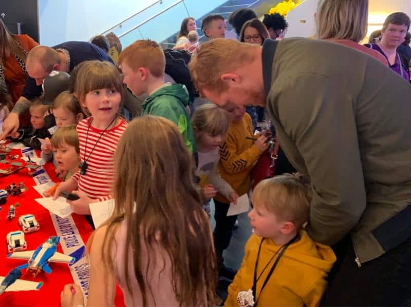 greg rutherford with kids at lego event