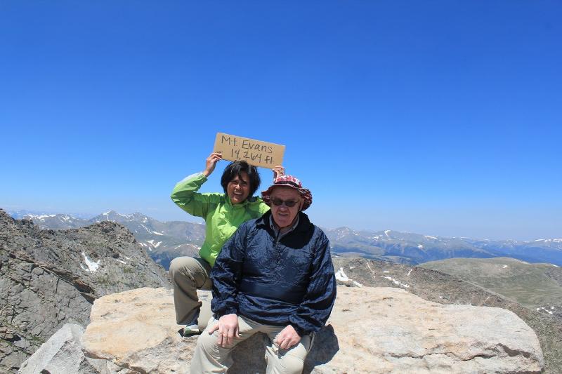 couple sitting at the top of Mount Evans Scenic Byway Colorado 