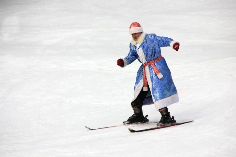 man dressed as santa claus skiing down hill