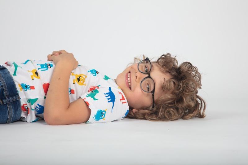 child smiling laying on the floor