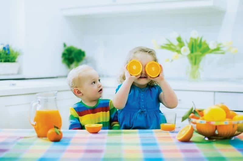 children drinking juice at a table