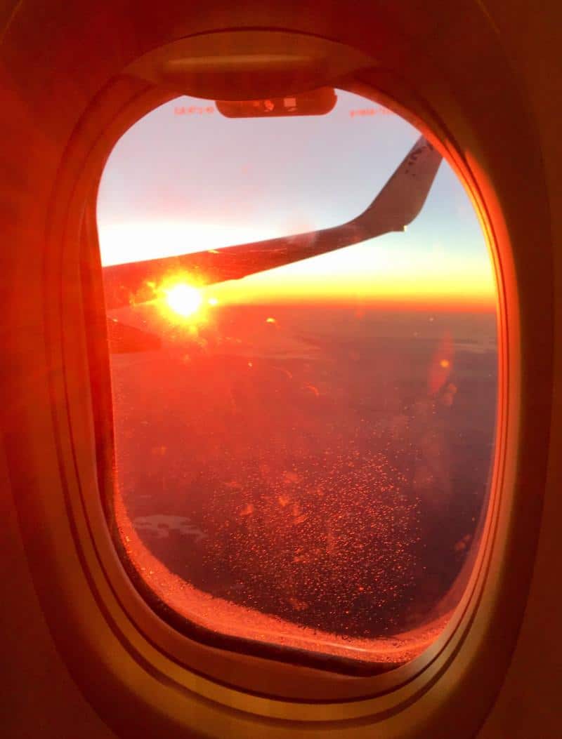 view of sunset from window seat on plane