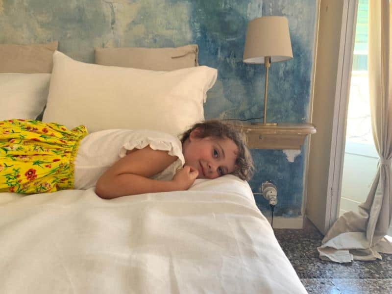 child laying on bed at casa rame genoa