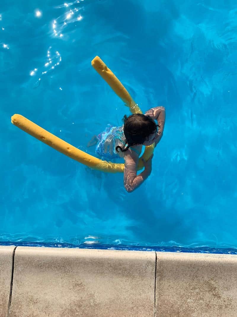 child swimming in genoa swimming pool