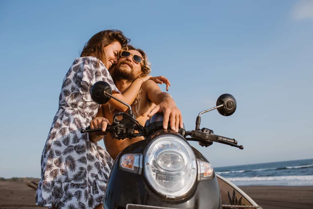 couple hugging on motorbike 