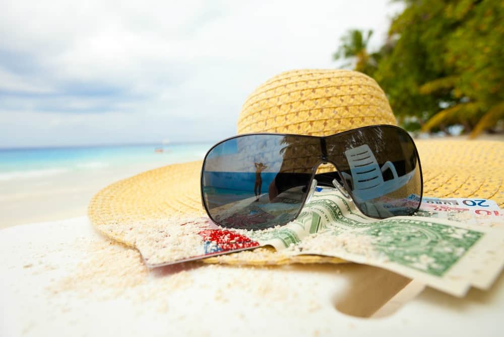 sunhat, glasses money on a beach .jpg