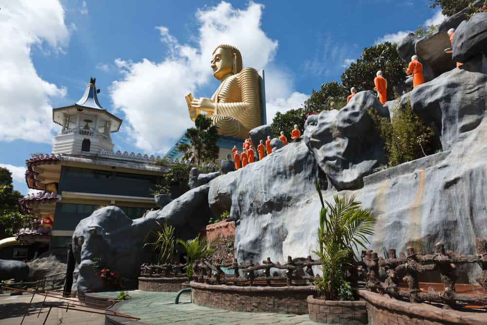 Buddhist monk statues going to Gold Buddha temple, Dambulla, Sri Lanka