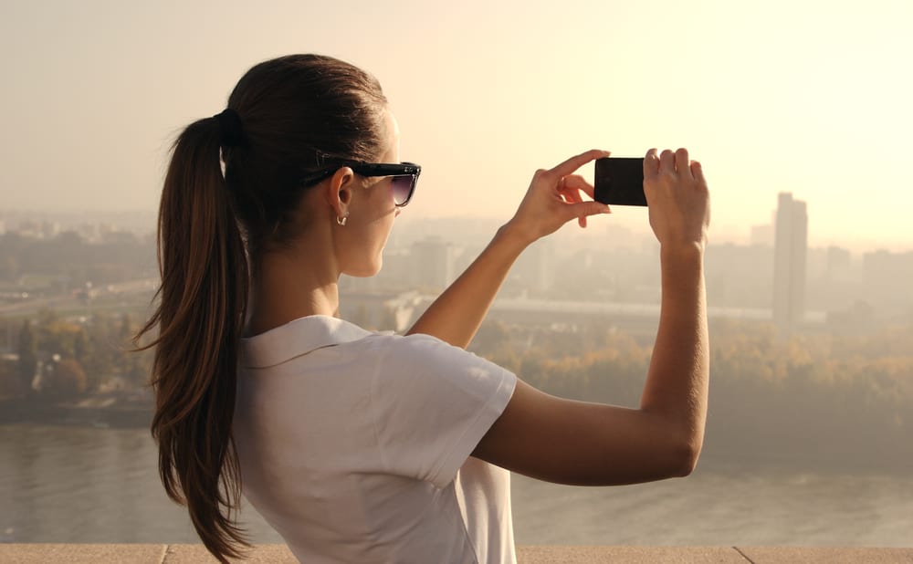 beautiful girl photographing city