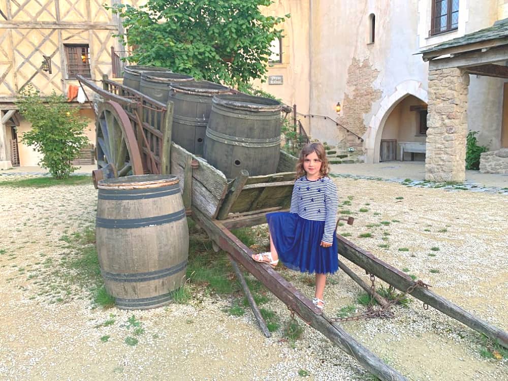 child in courtyard of la citadelle hotel puy du fou