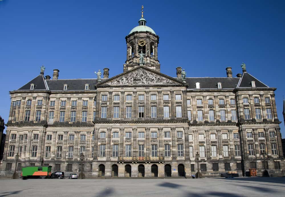 royal palace  next to nieiwe kerk new church on dam square amsterdam holland netherlands