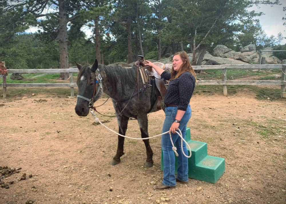 wrangler with horse at dude ranch