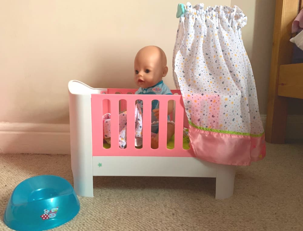 baby born doll in cot