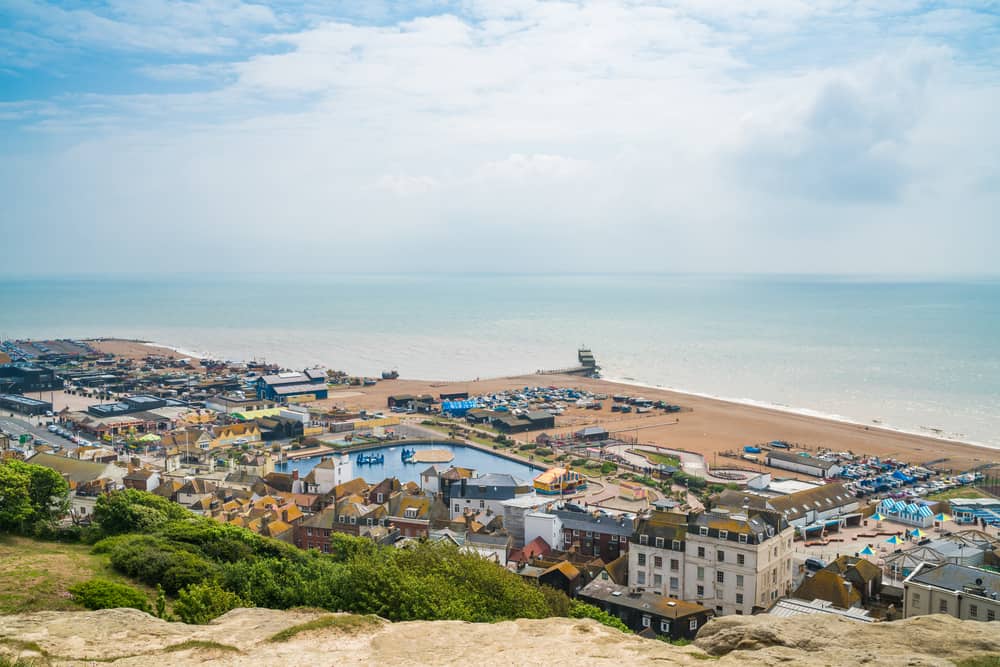 HASTINGS, UK - MAY 13 2017: View of seafront from West Hill in Hastings, East Sussex, UK. The town is a popular seaside resort and a fishing port with a beach-based fishing fleet.