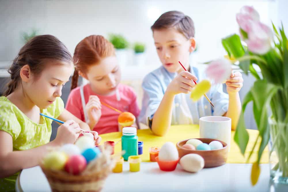 Group of friends painting eggs before Easter
