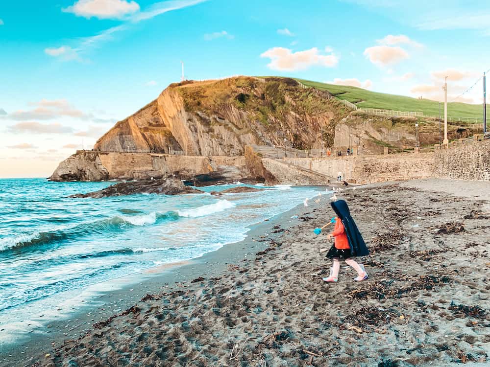 child on ilfracombe beach with spade