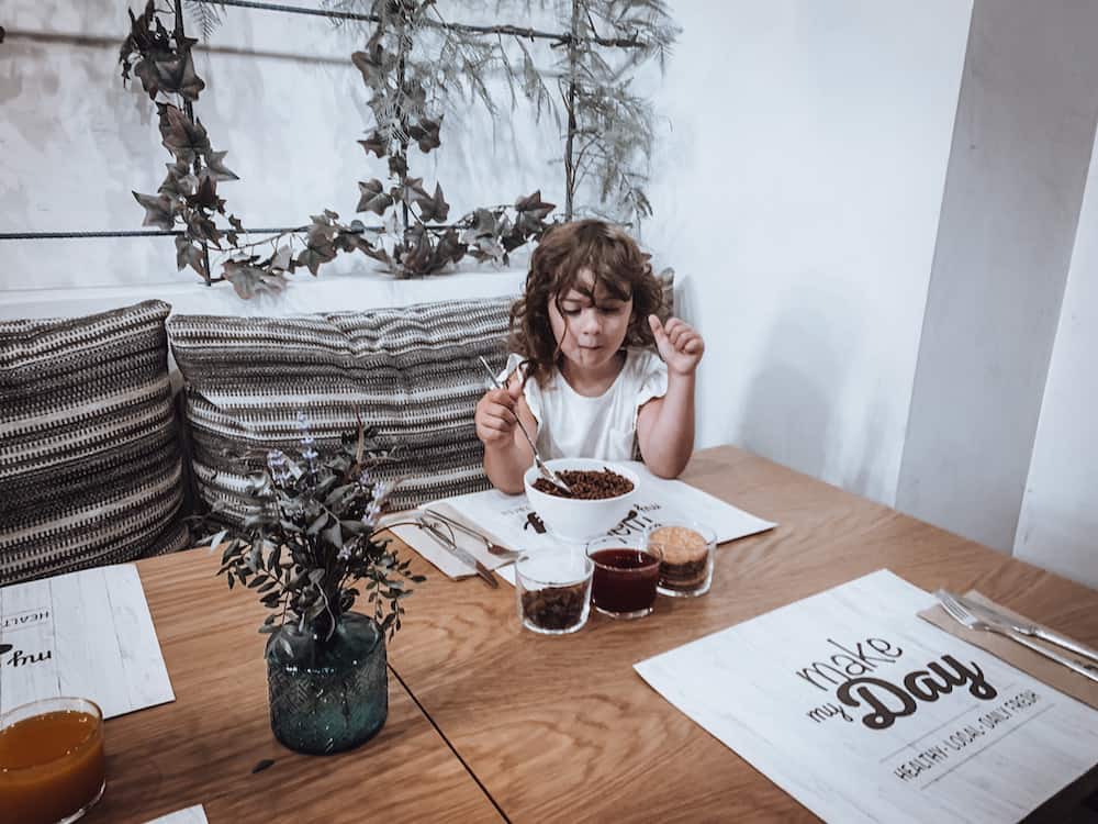 child eating breakfast in hotel restaurant 