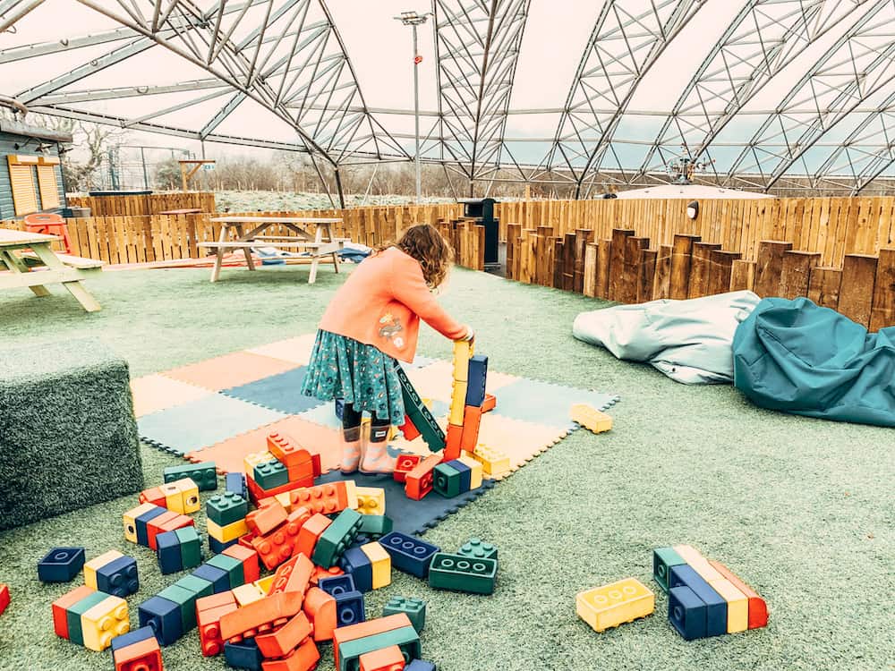 child playing with bricks in serendome 