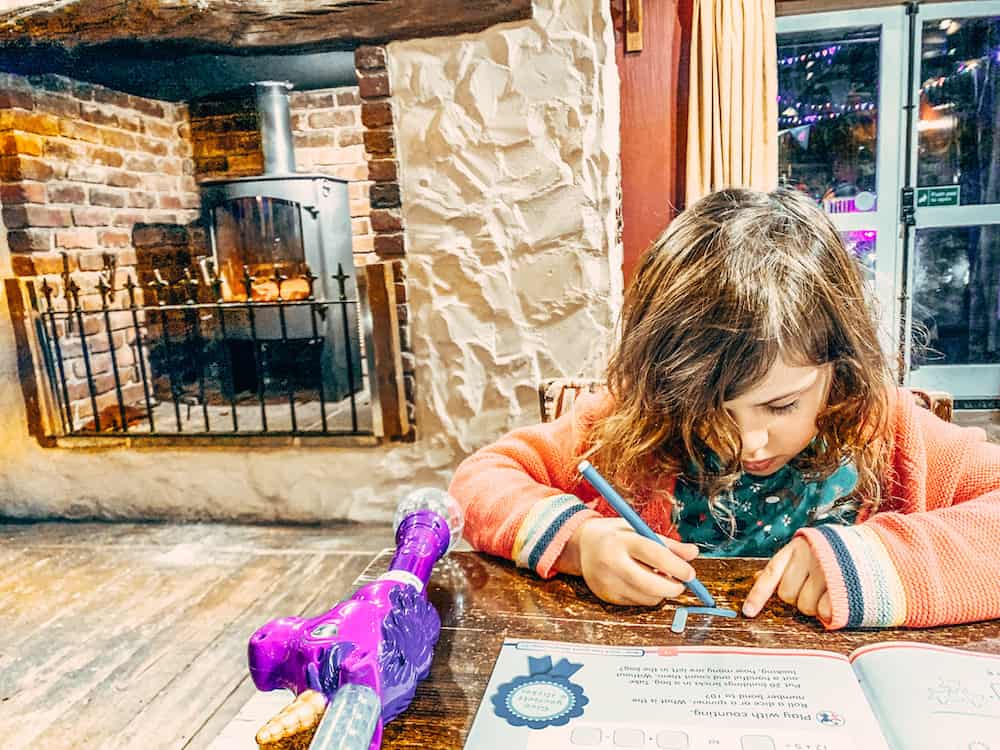 child drawing at table at pub at bluestone 