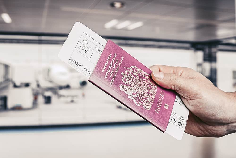 Handing over boarding pass and passport to embark on a flight in an airport