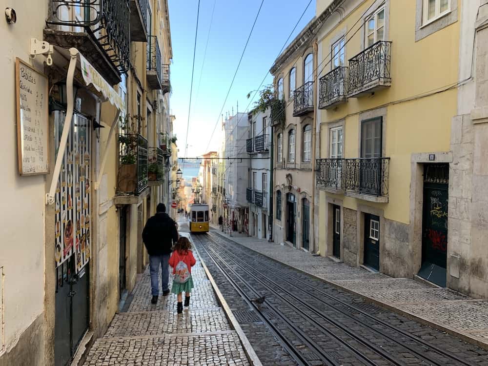 family walking along tram line 