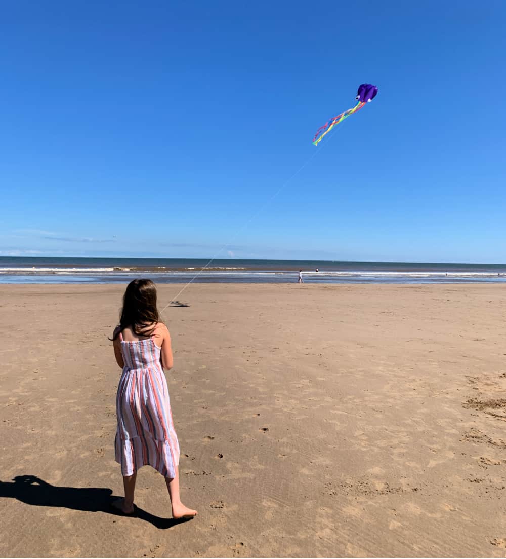 flying a kite at beach