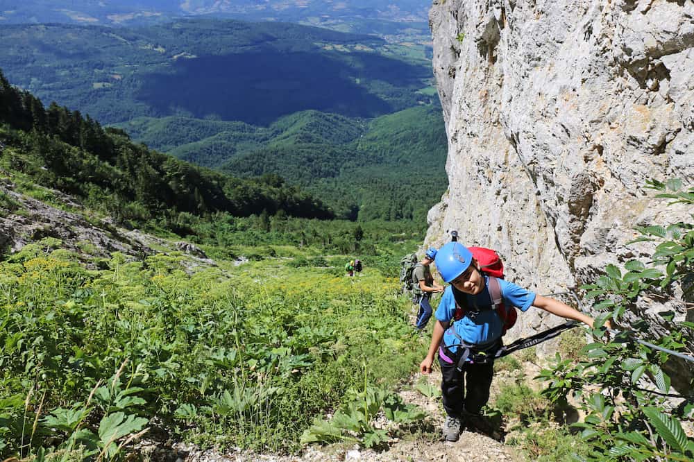 Young Hikers climbing Via Ferrata at mountain 