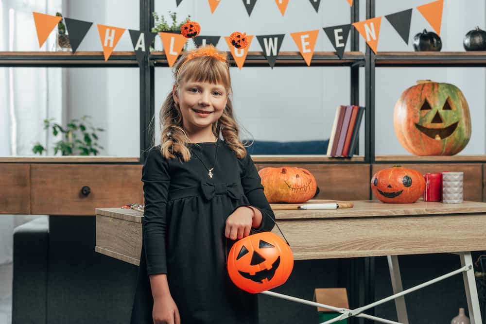 girl holding halloween bucket 