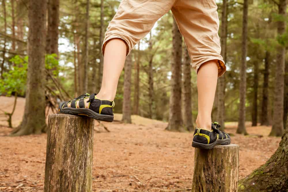 Boy balancing on trees - jumping from one to the other.