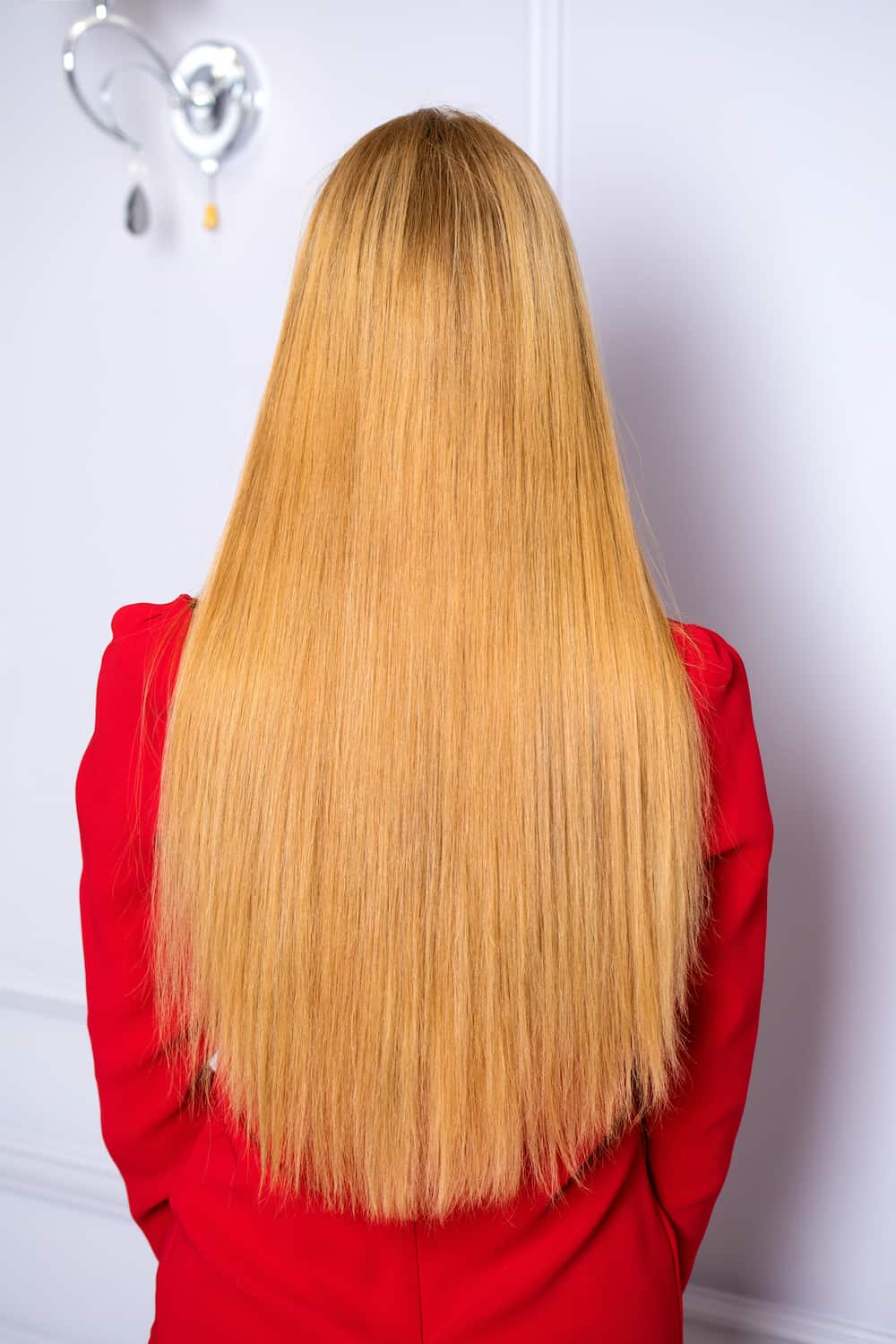 Female long straight blonde hair, rear view, against the backdrop of beauty salon