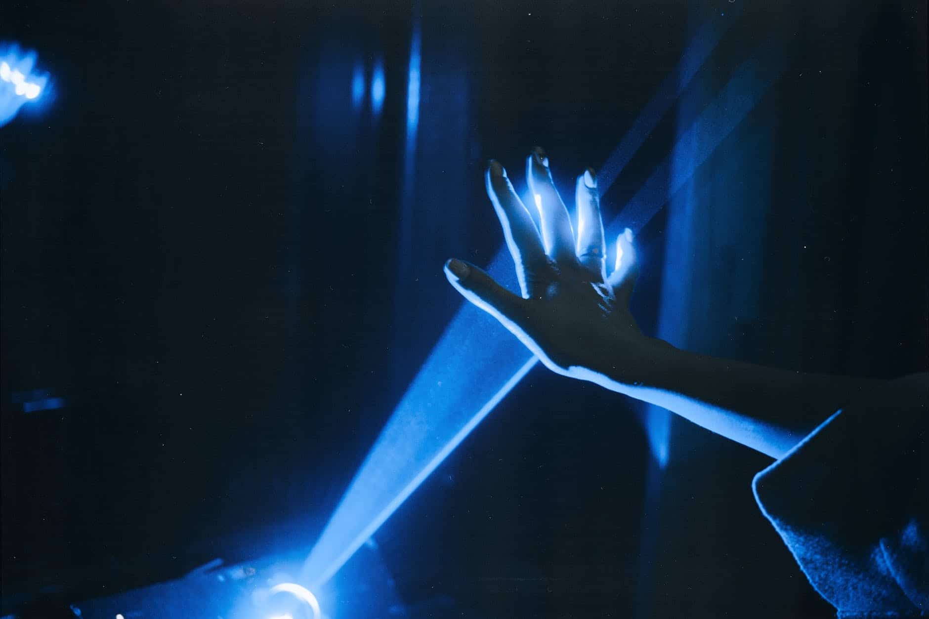 pexels-photo-3345270 photo of person s hand with blue light