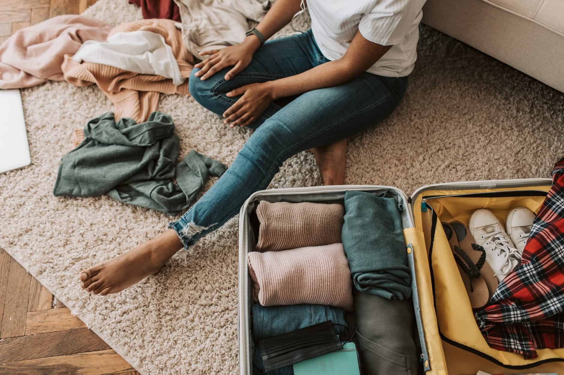 a woman packing her suitcase