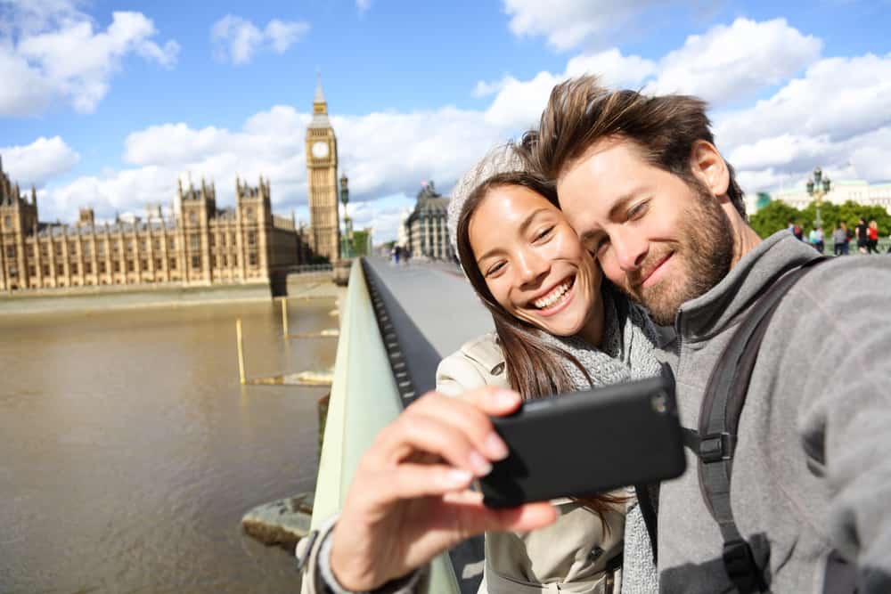 London tourist couple taking photo near Big Ben