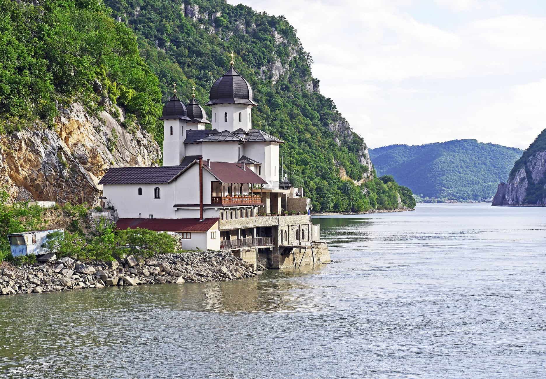 iron-gate-karparten-danube-gorge-abbey-163572 white and black house located at riverside on mountain slope at daytime