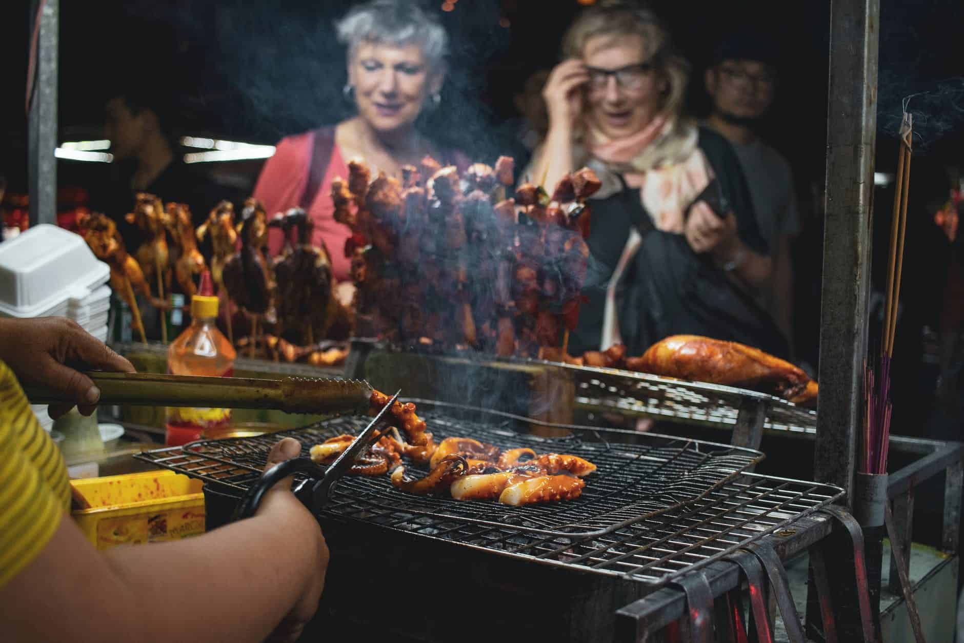 people watching barbecues getting cooked