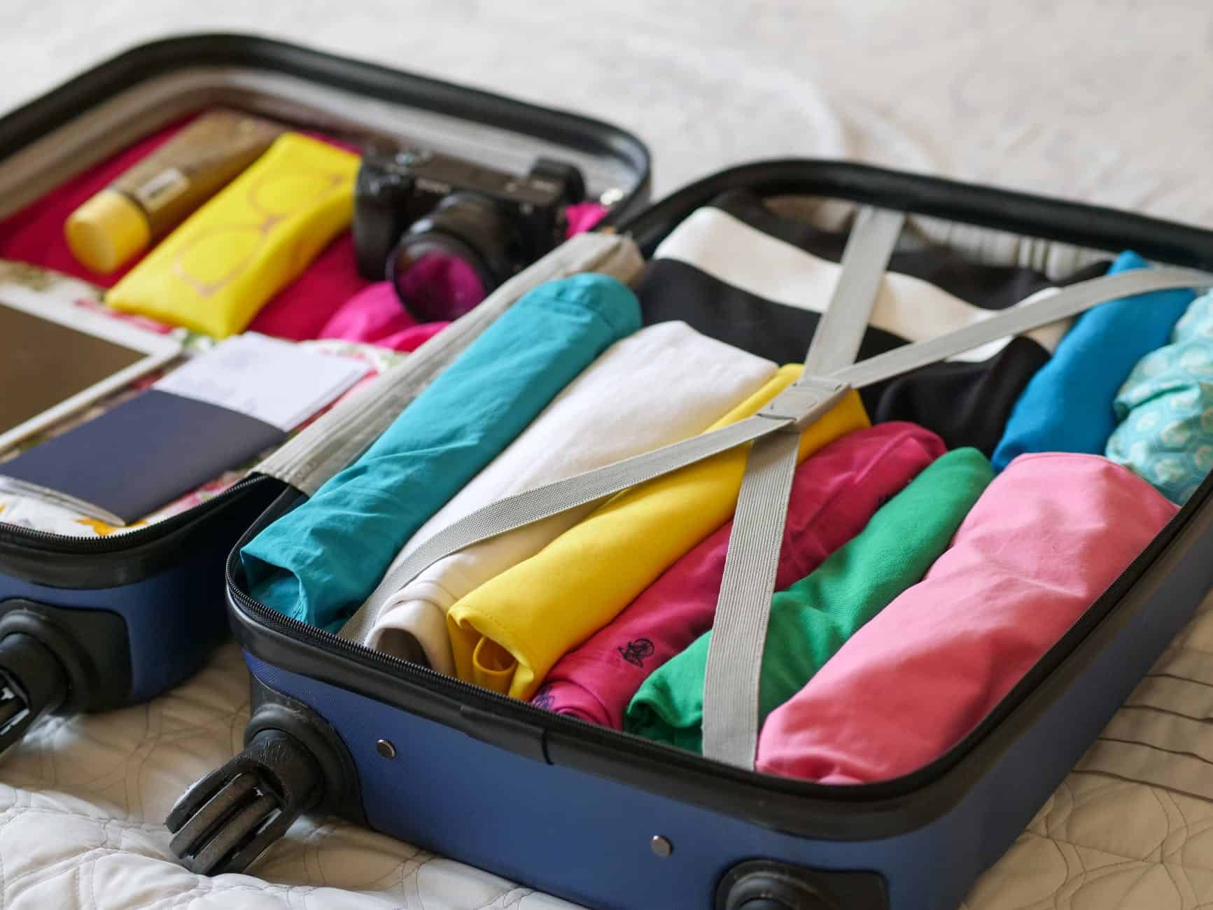 blue luggage with folded clothes