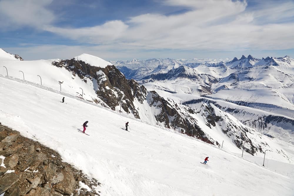 Skiing slopes in the French Alps, Alpe d'Huez, unrecognizable skiers descending