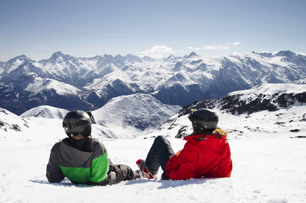 Young happy couple lying in snowy mountains,alps