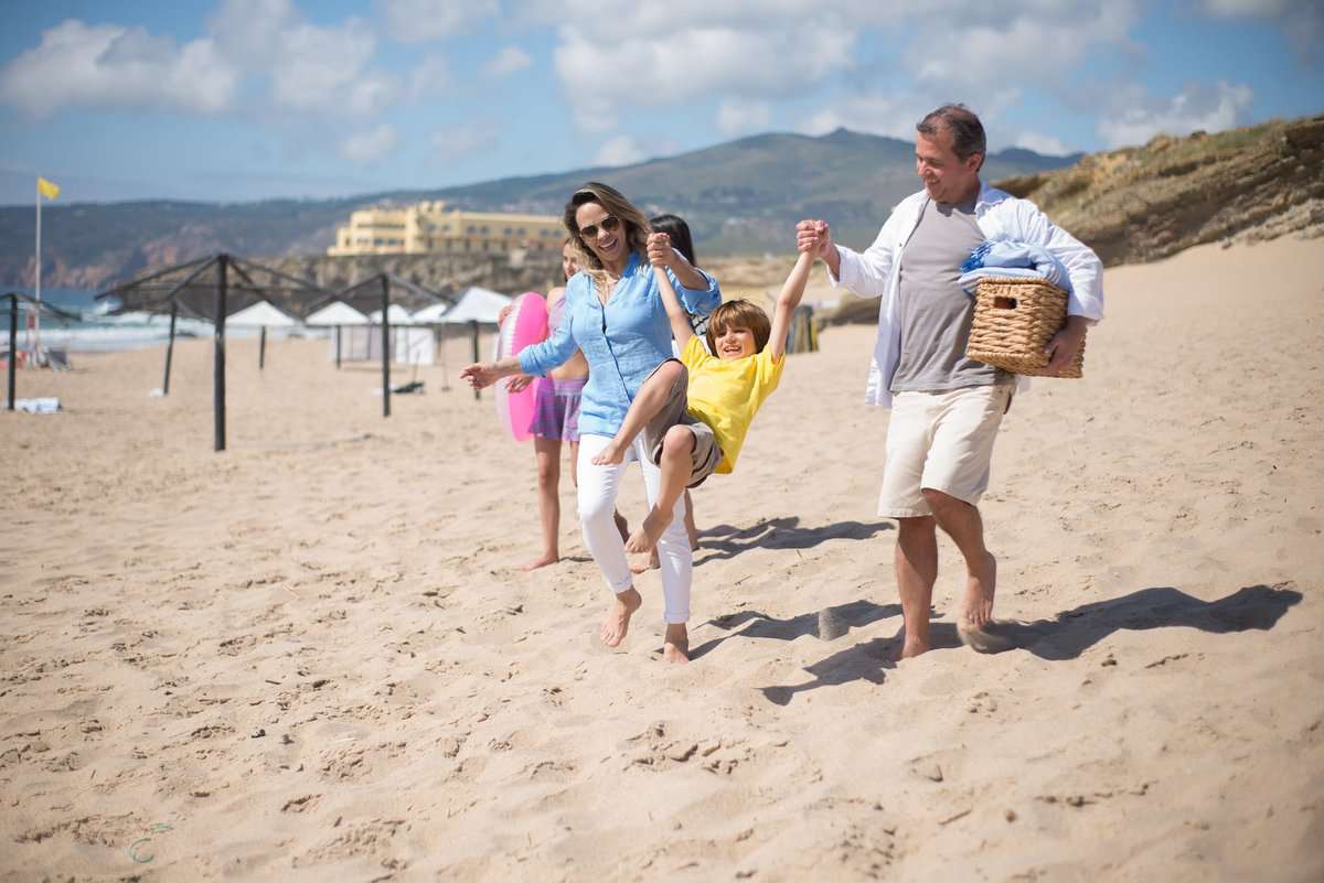 family walking together in the beach