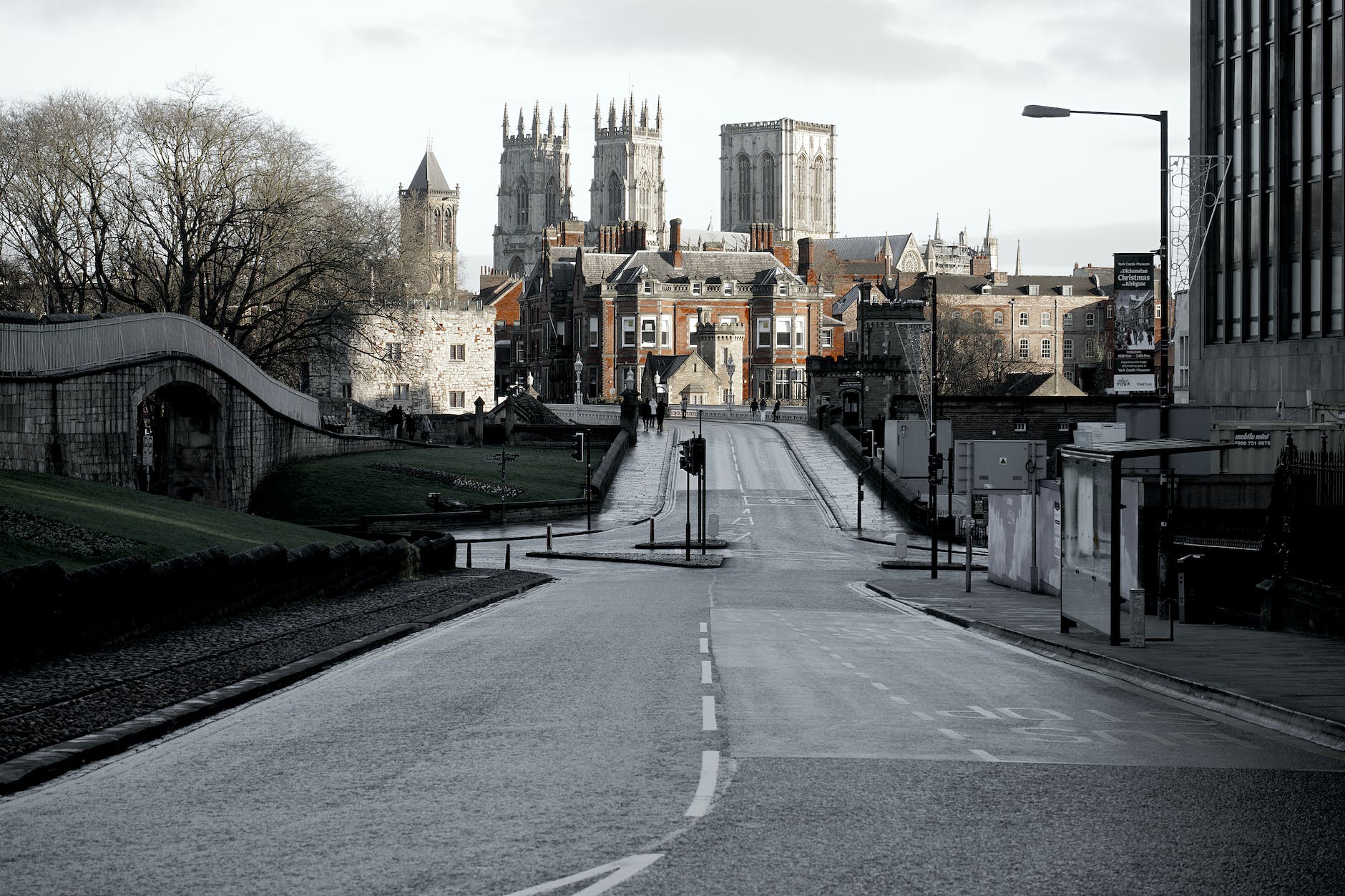 brown buildings on end of road under cloudy sky