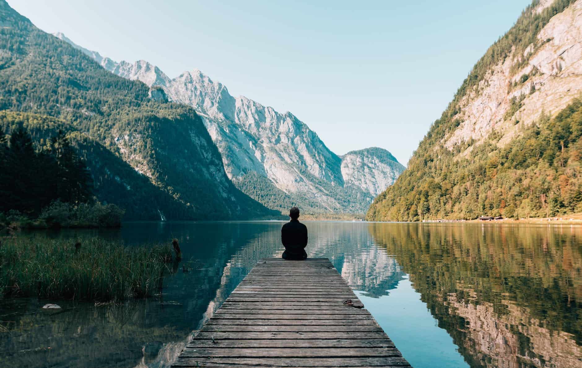 pexels-photo-747964 a person sitting on wooden planks across the lake scenery
