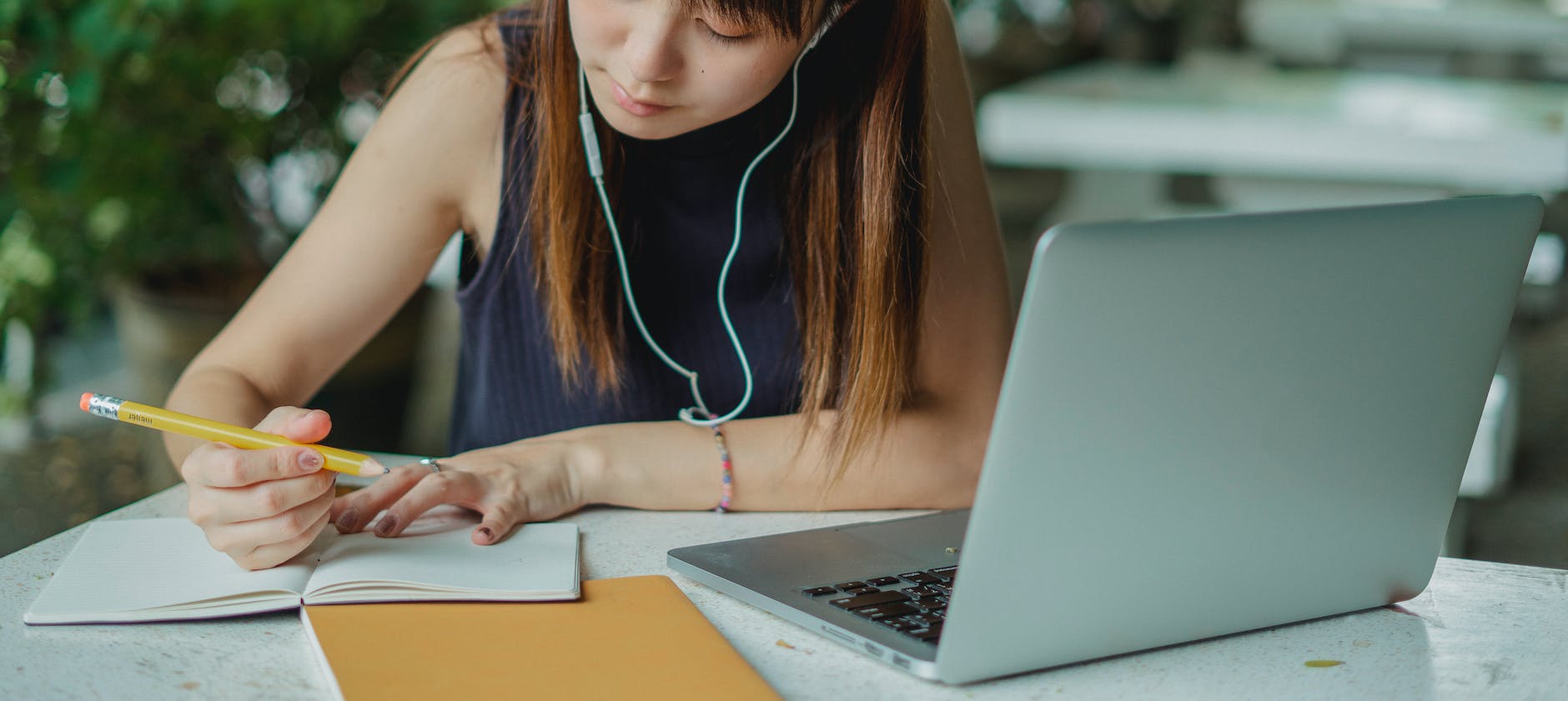 pexels-photo-5538616 woman in blue tank top using macbook pro