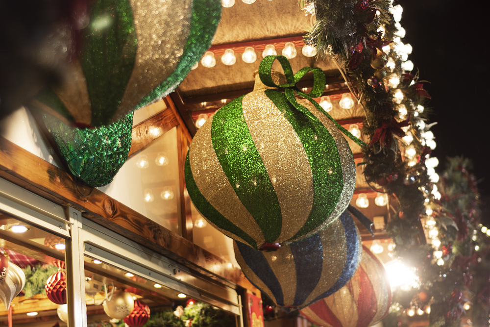 Nottingham, United Kingdom - December 14, 2019 - Beautiful outdoor decoration, big green glowing bauble at Nottingham Christmas market holiday.