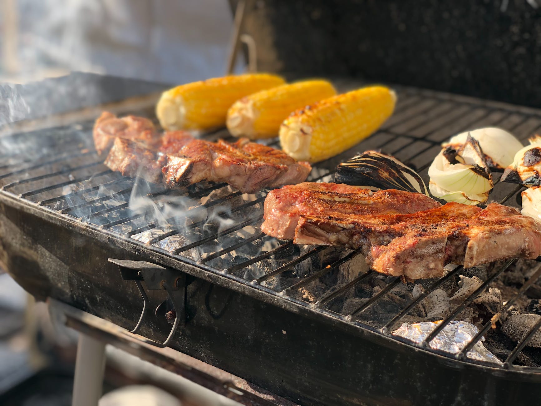 photograph of meat being grilled