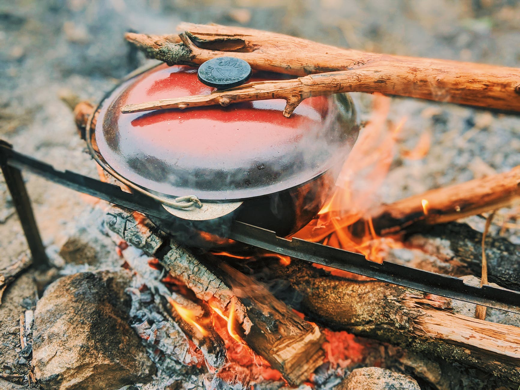 burning firewood with pot in nature