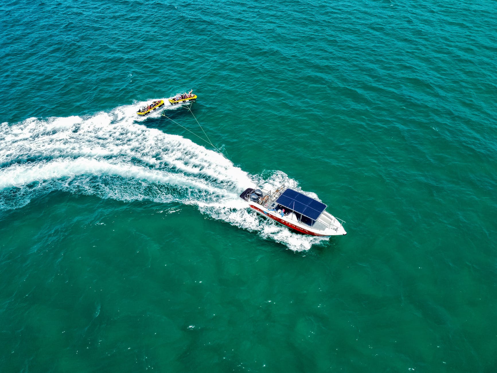 pexels-photo-13315548 a motorboat tugging rubber boats